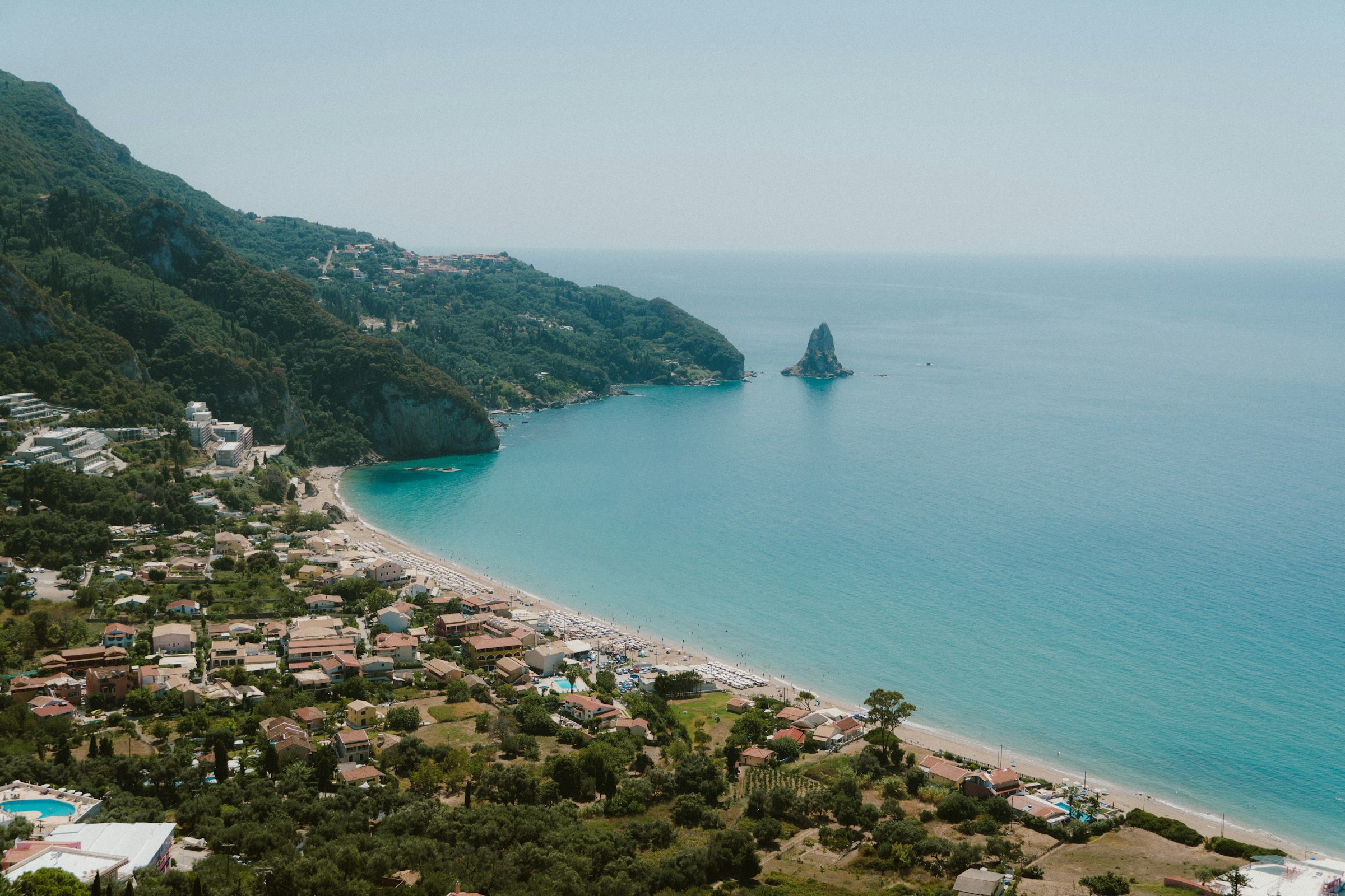 Agios Gordios bay with the Ortholithi rock and green hills, Corfu