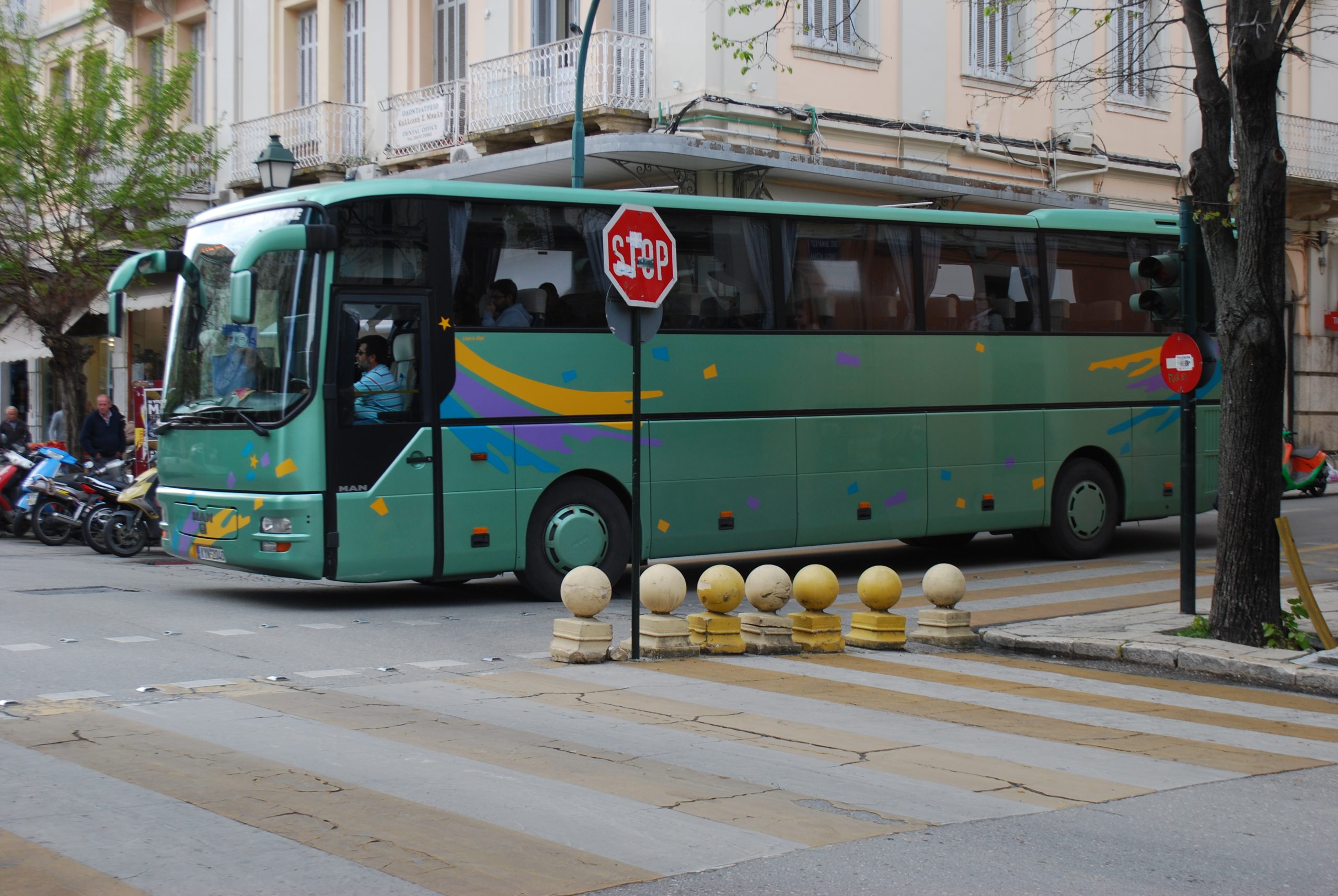 A green intercity bus in Corfu Town