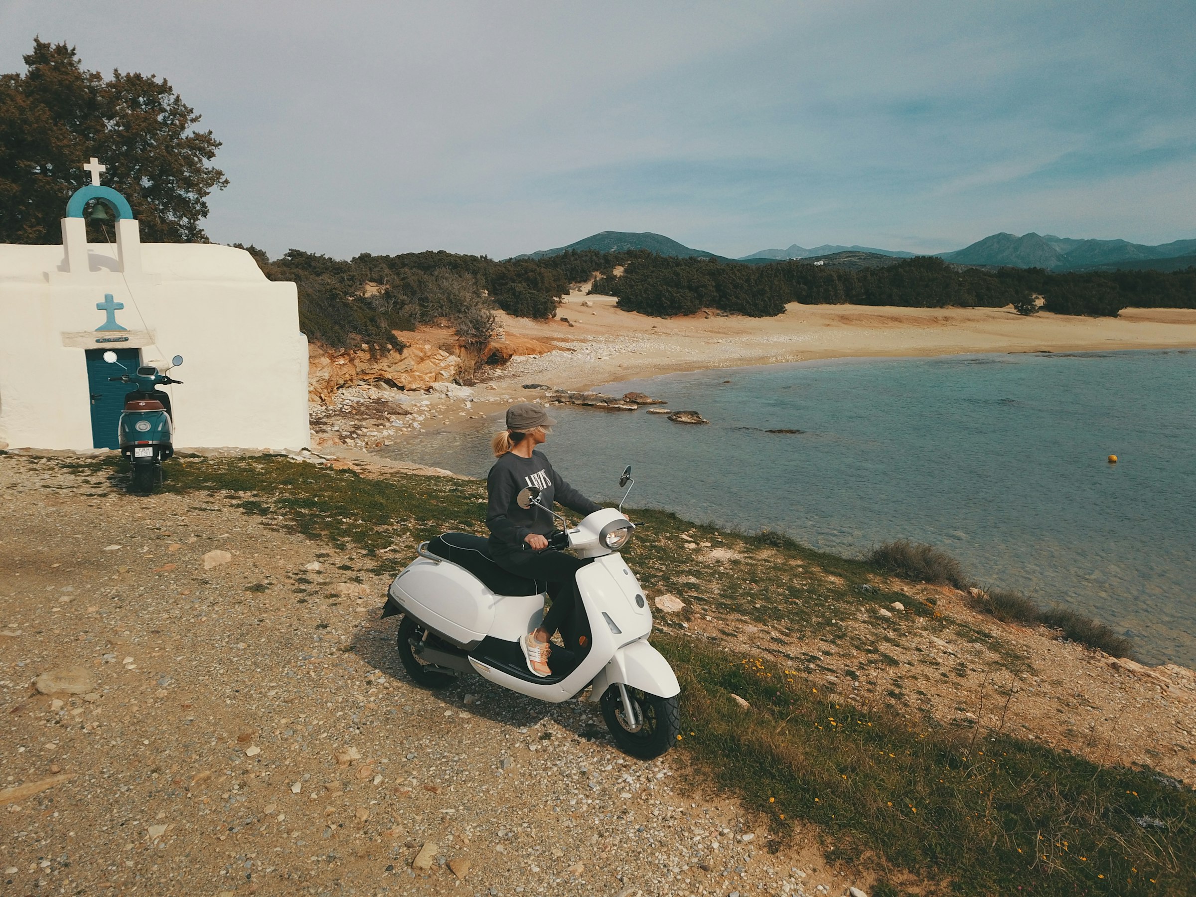 Electric scooter by a bay on a Greek island