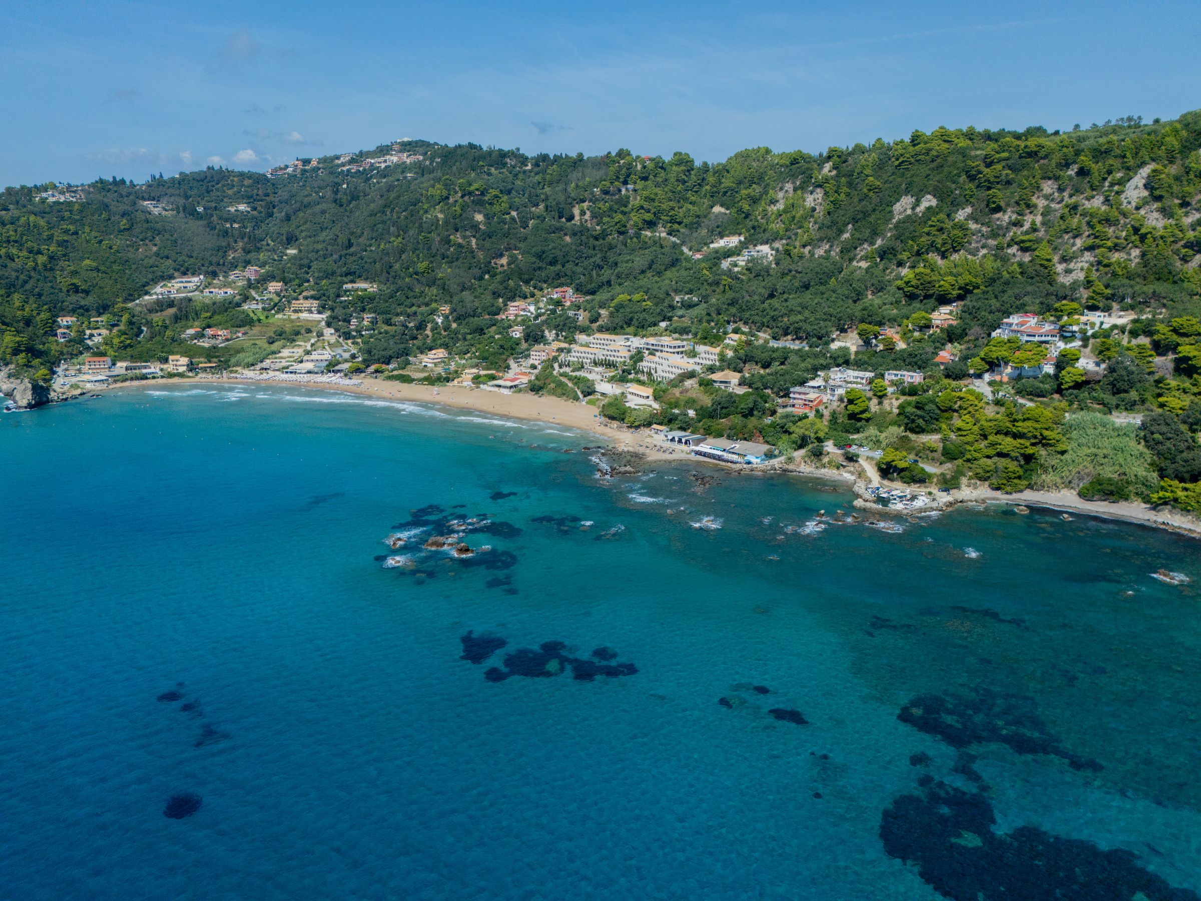 Aerial view of Glyfada beach and its wooded hillside, Corfu